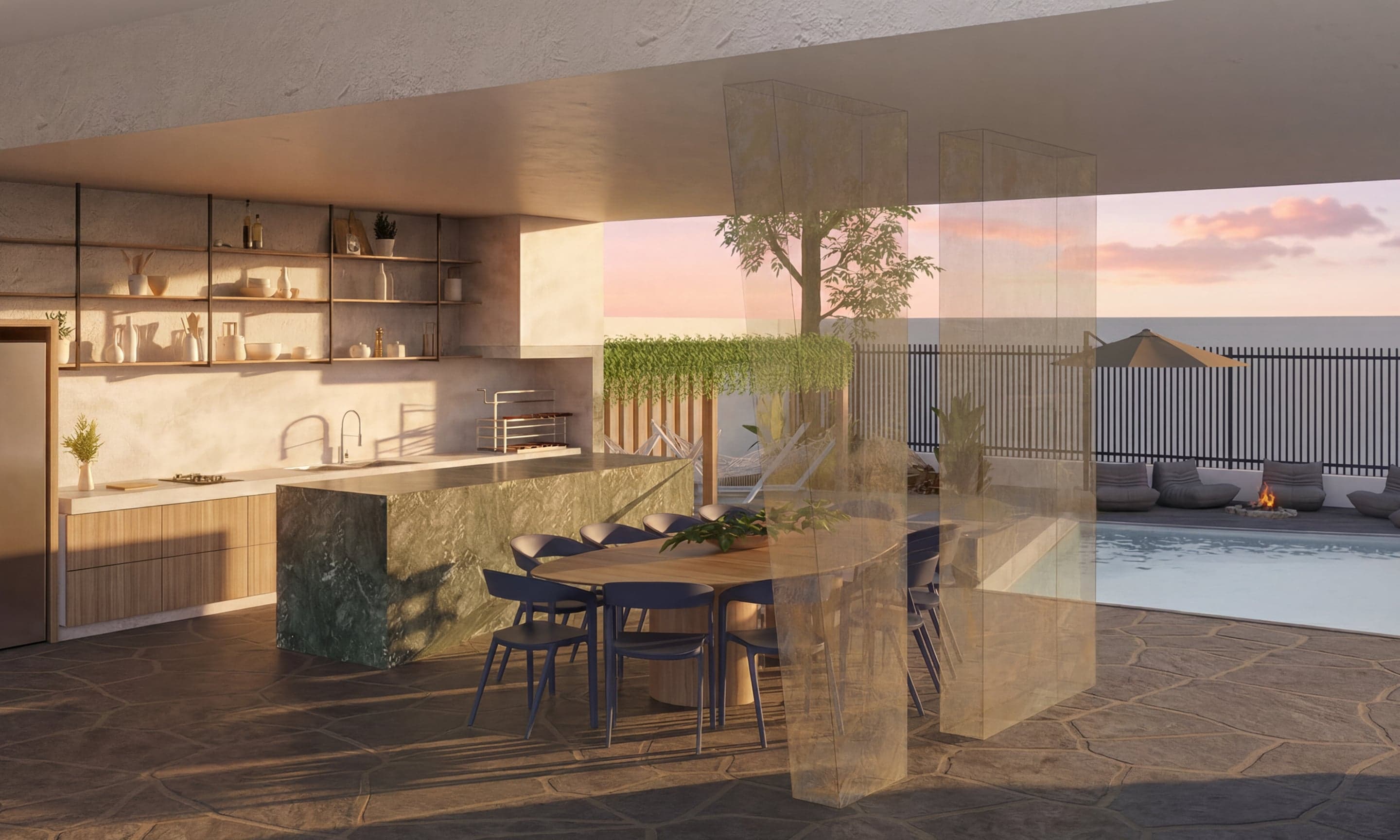 Área gourmet com ilha em mármore verde, mesa de jantar e piscina com vista para o mar ao pôr do sol, projeto de arquitetura no litoral do Ceará